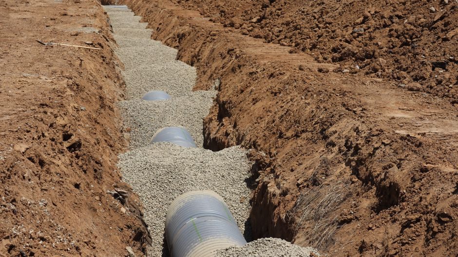 Detailed view of drainage pipe construction in a trench, Elk Grove, California.